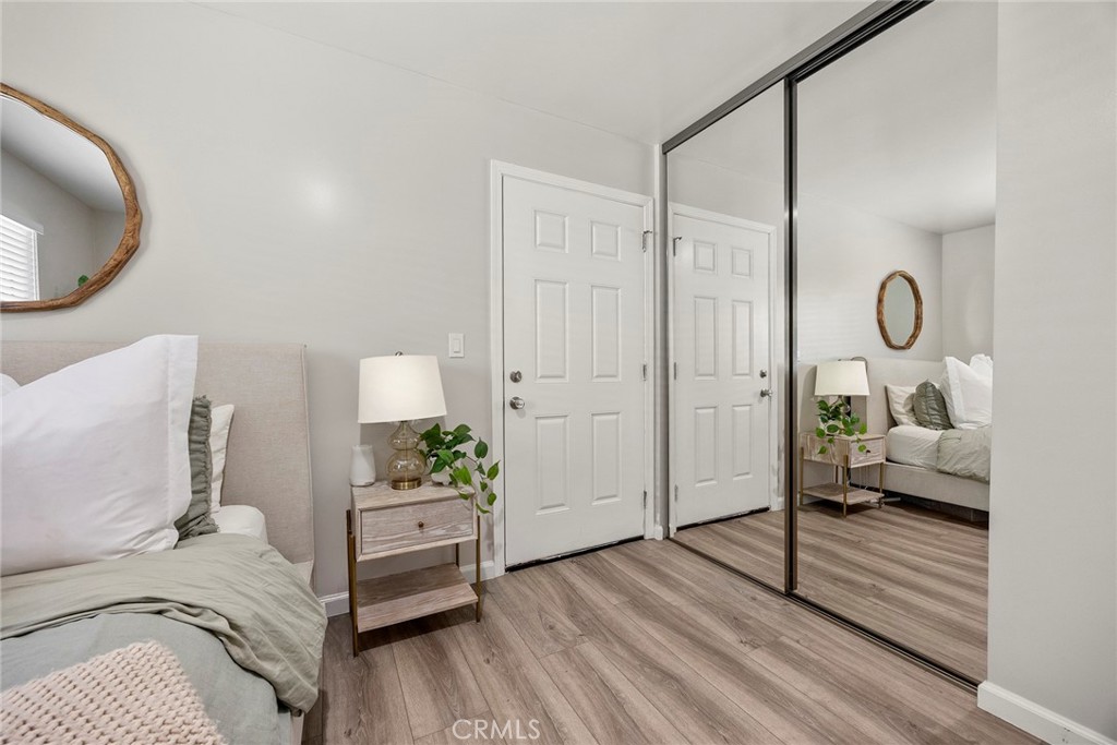 11629 185th Street Artesia, CA 90701 - Photo 14 of 20 a bedroom with a bed and wooden floor