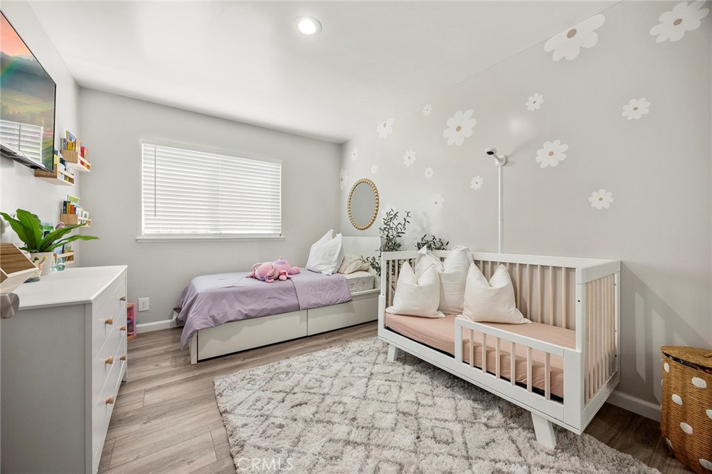 11629 185th Street Artesia, CA 90701 - Photo 15 of 20 a spacious bedroom with a bed and a chandelier