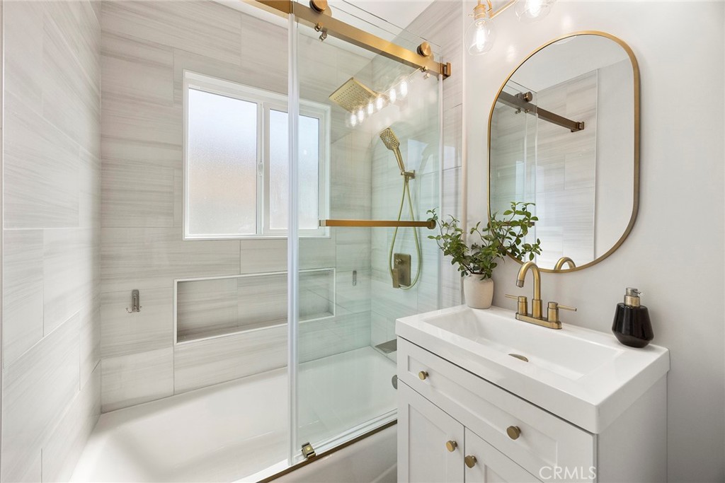 11629 185th Street Artesia, CA 90701 - Photo 10 of 20 a bathroom with a sink a potted plant and mirror