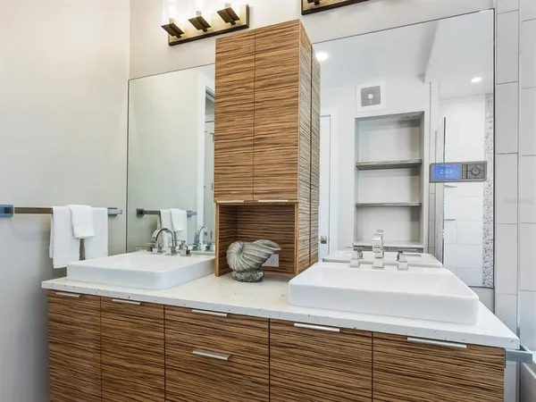 a view of a kitchen with kitchen island a stove a sink and a refrigerator