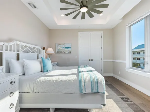 a bedroom with furniture and wooden floor