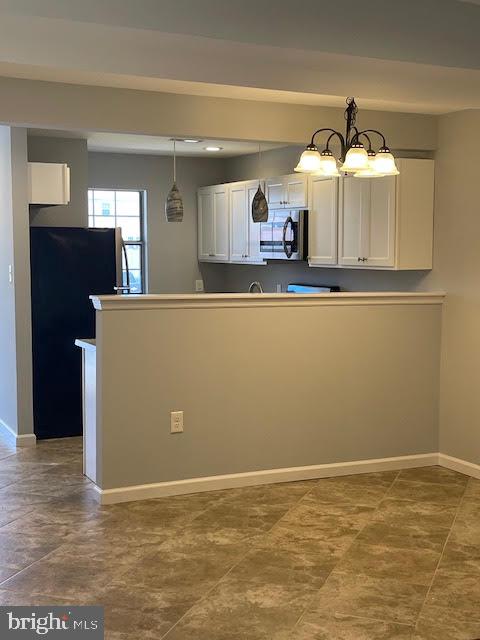508 Blackbird Drive Bear, DE 19701 - Photo 2 of 22 a view of a kitchen with furniture and a chandelier