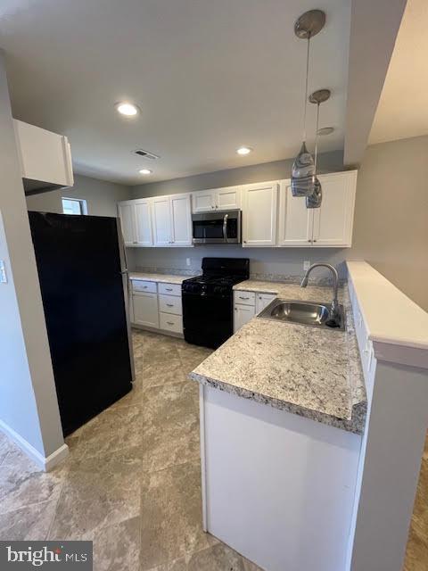 508 Blackbird Drive Bear, DE 19701 - Photo 4 of 22 a kitchen with a sink a stove and refrigerator