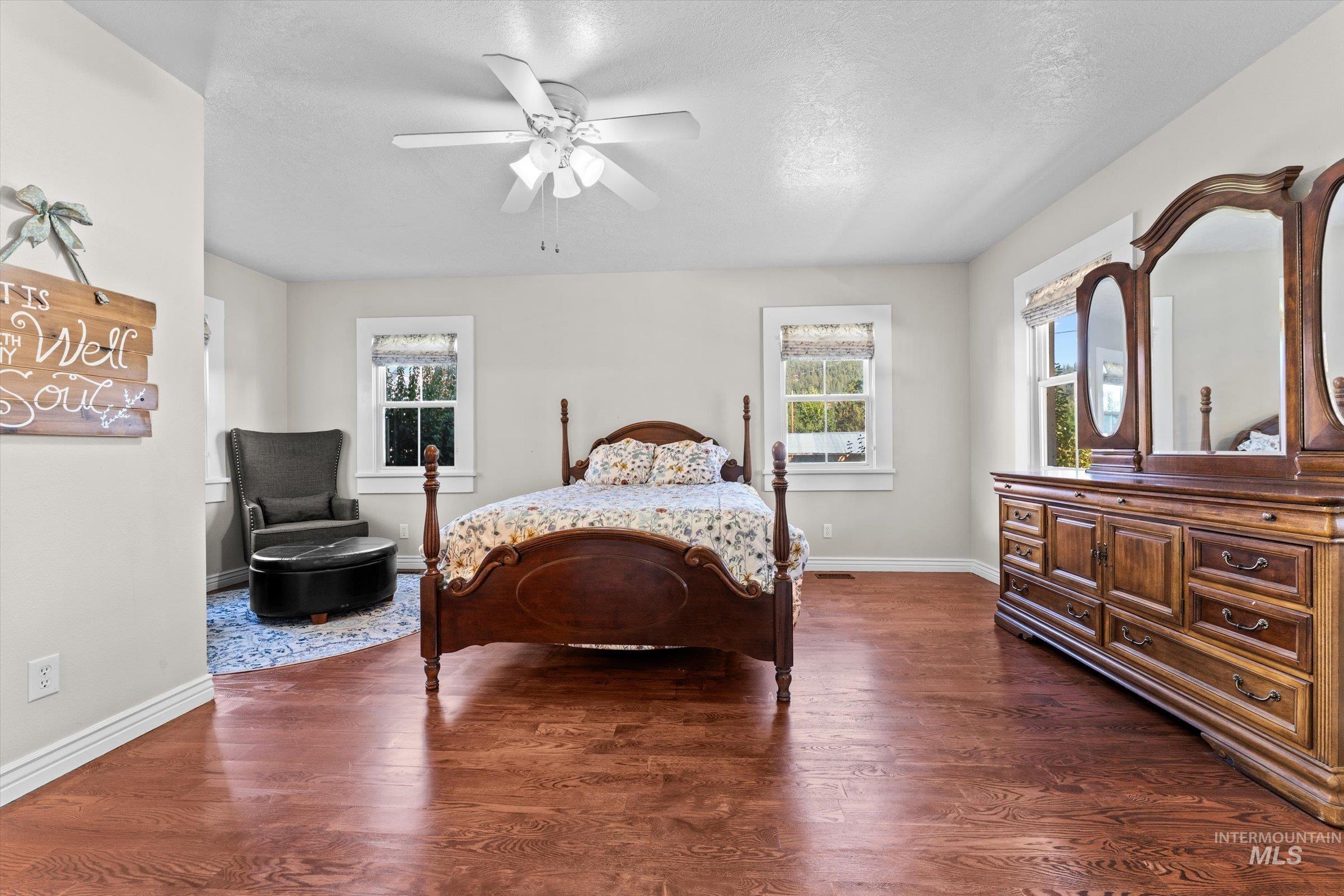 315 South Middlefork Road Garden Valley, ID 83622 - Photo 37 of 49 Bedroom featuring dark wood-type flooring, a ceiling fan, and a textured ceiling