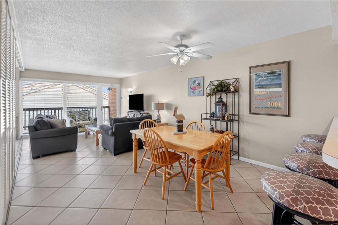 14810 Windward Drive, Unit 402 Corpus Christi, TX 78418 - Photo 11 of 39 a dining room with furniture and window