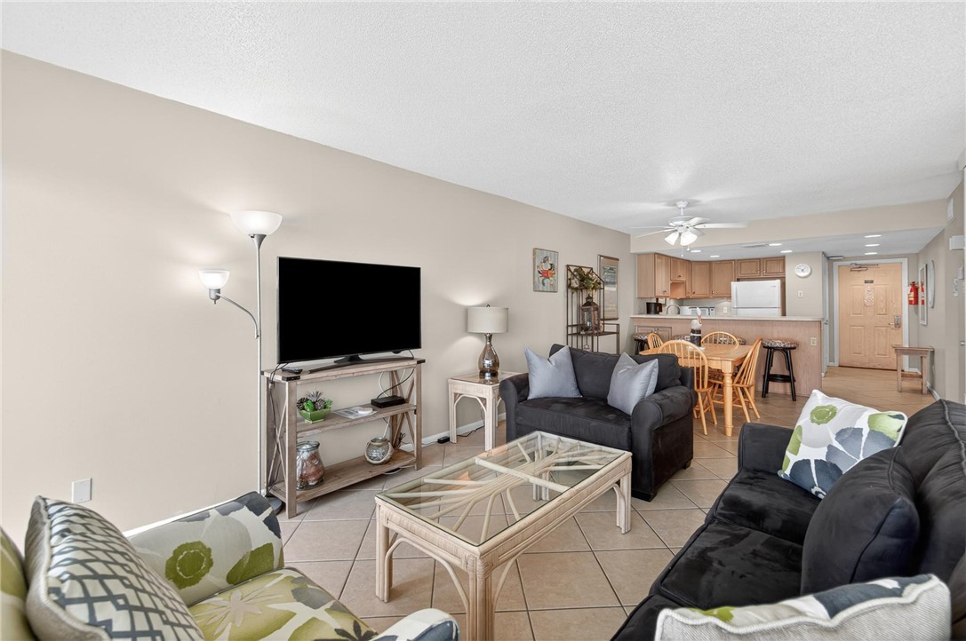 14810 Windward Drive, Unit 402 Corpus Christi, TX 78418 - Photo 12 of 39 a living room with furniture and a flat screen tv