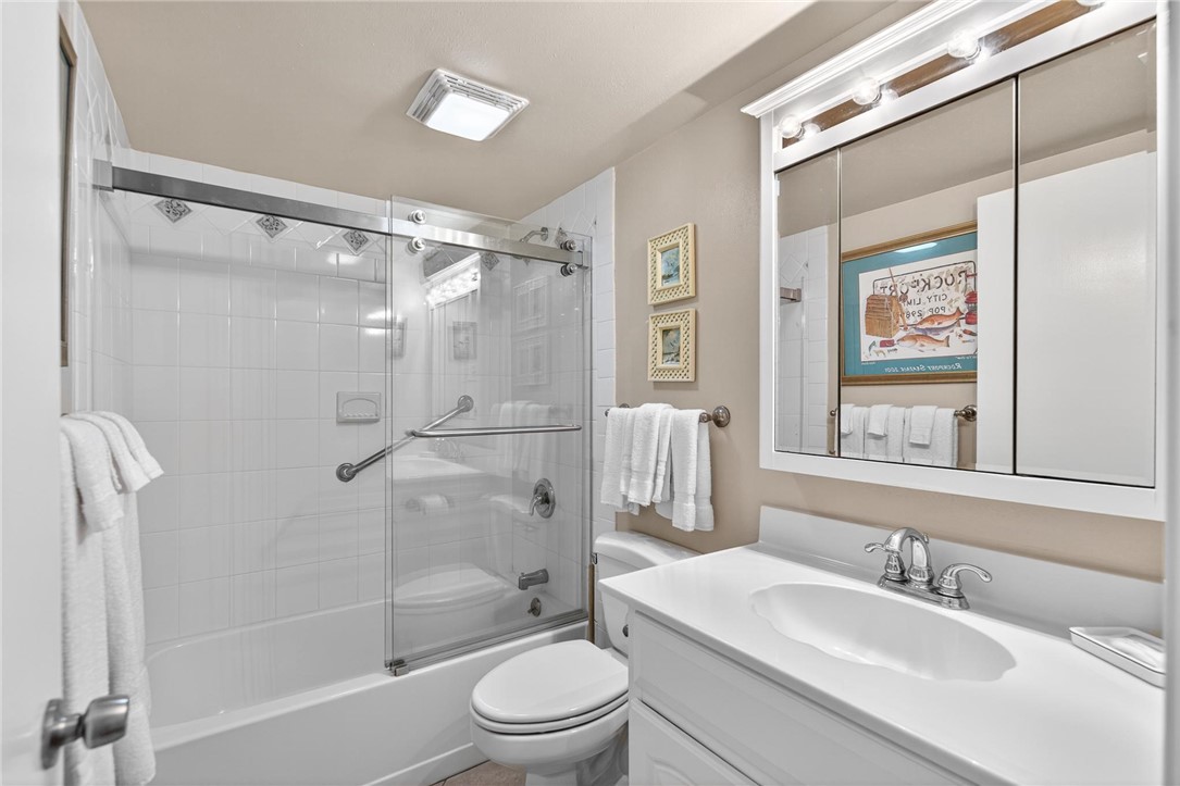 14810 Windward Drive, Unit 402 Corpus Christi, TX 78418 - Photo 18 of 39 a bathroom with a sink a toilet and shower