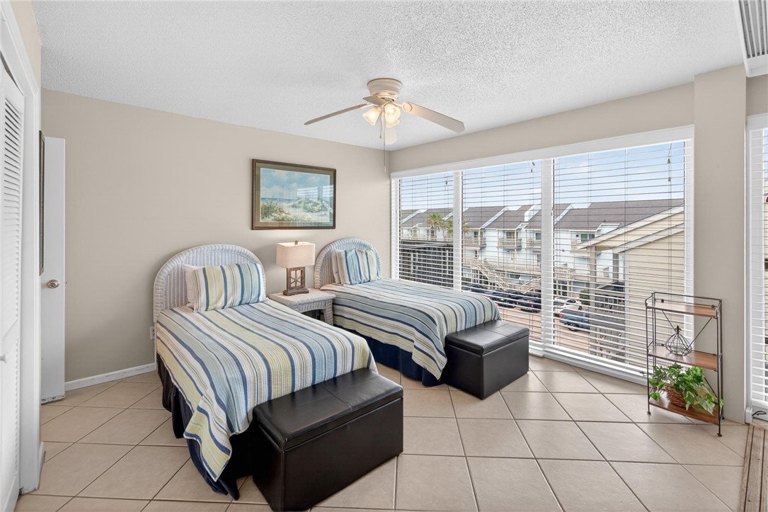 14810 Windward Drive, Unit 402 Corpus Christi, TX 78418 - Photo 20 of 39 a bedroom with furniture and a large window