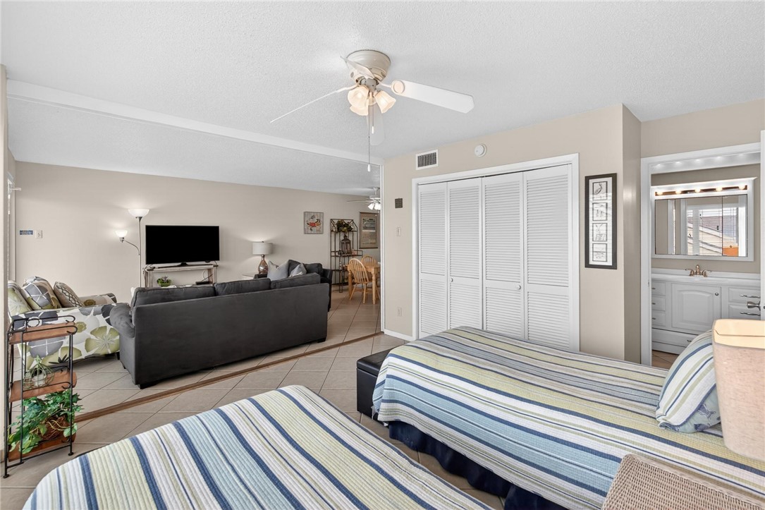 14810 Windward Drive, Unit 402 Corpus Christi, TX 78418 - Photo 21 of 39 a living room with furniture and a flat screen tv