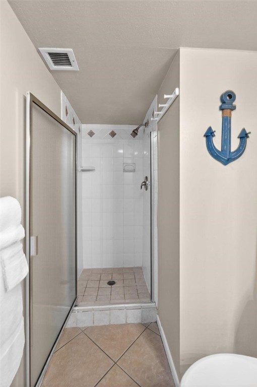 14810 Windward Drive, Unit 402 Corpus Christi, TX 78418 - Photo 25 of 39 a bathroom with a shower and toilet