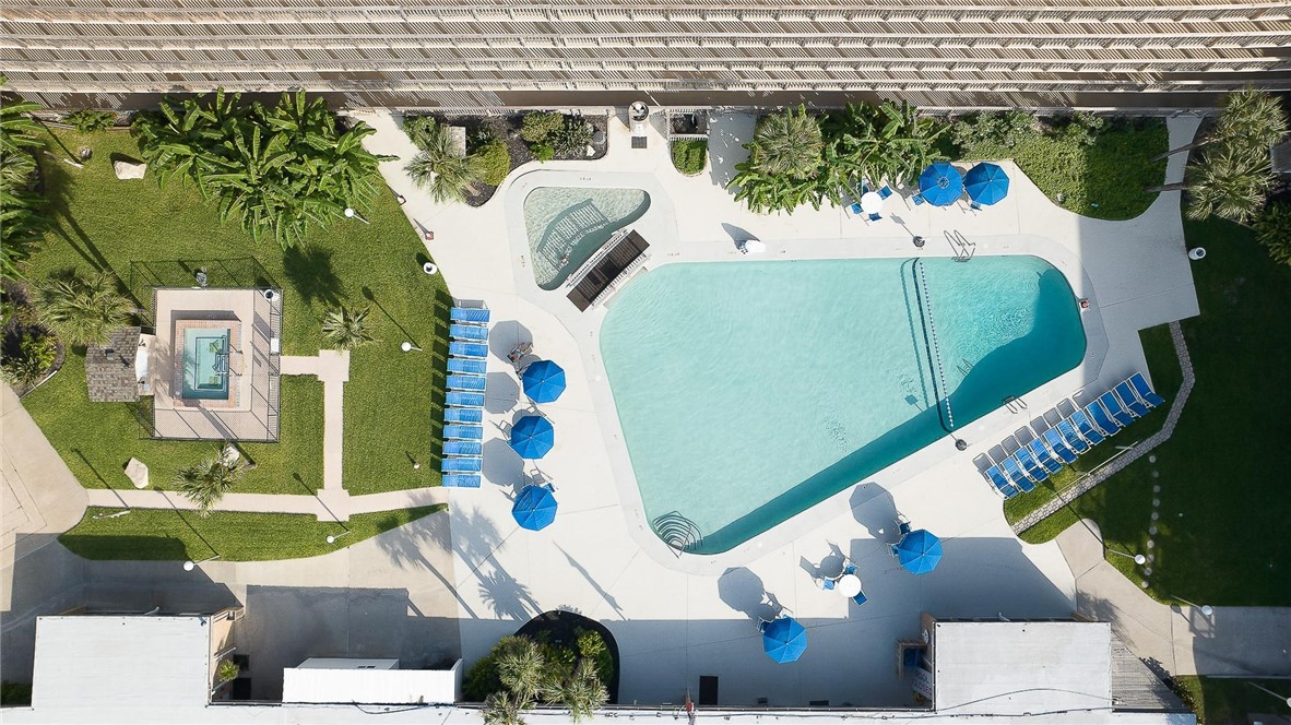 14810 Windward Drive, Unit 402 Corpus Christi, TX 78418 - Photo 35 of 39 an aerial view of a house with a garden and parking