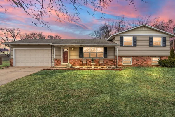 a front view of house with yard and green space