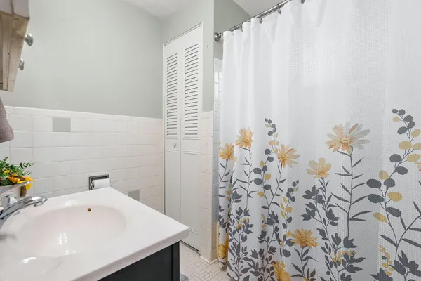 a bathroom with a sink and a shower curtain