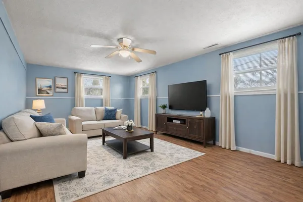 a living room with furniture and a flat screen tv