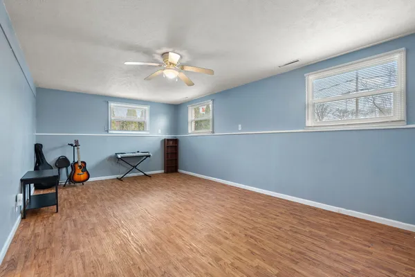 a view of a livingroom with a window and wooden floor