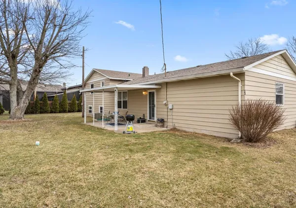 a view of a house with a yard patio and fire pit