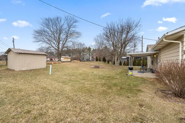 a view of a yard with a house and a tree