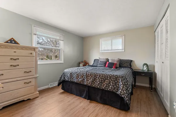 a bedroom with a bed and a window