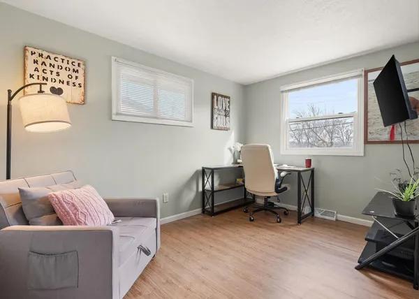 a view of a livingroom with workspace and a couch