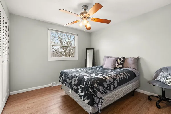 a bedroom with a bed and a chandelier