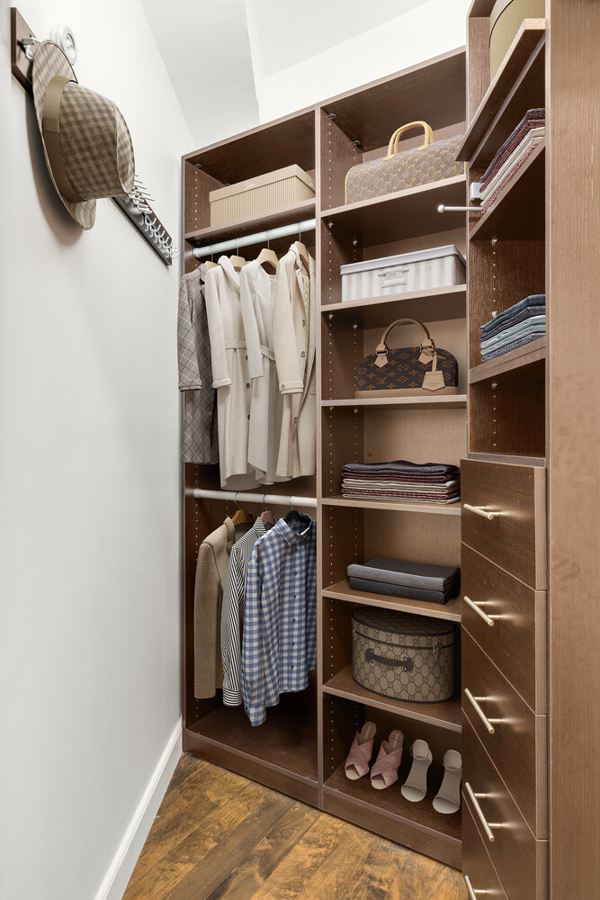 150 West 26th Street, Unit 802 Manhattan, NY 10001 - Photo 12 of 13 a view of walk in closet with clothes and shoes