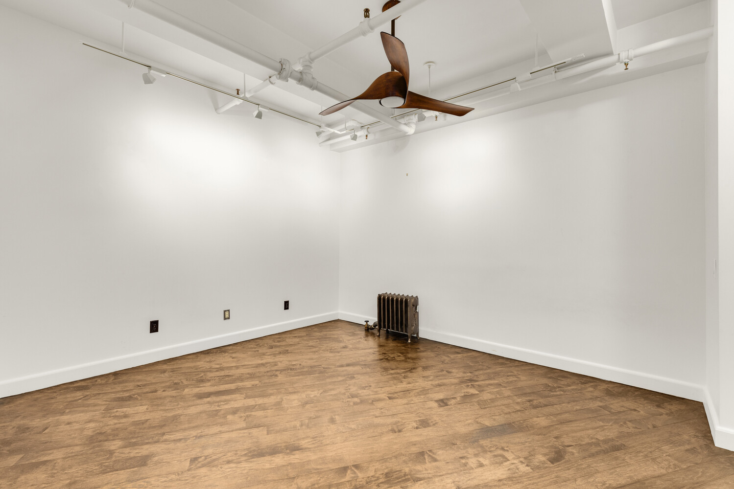 150 West 26th Street, Unit 802 Manhattan, NY 10001 - Photo 7 of 13 an empty room with a ceiling fan and carpet