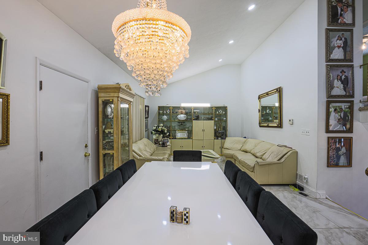 3111 Parkington Avenue Baltimore, MD 21215 - Photo 11 of 47 a living room with furniture and a chandelier