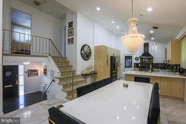a large kitchen with a table and a large window