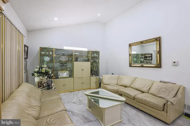 a living room with furniture and flowers