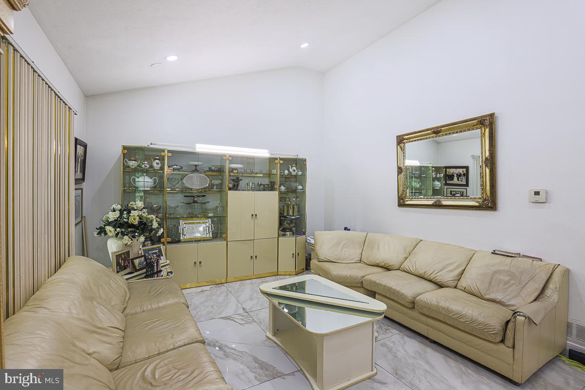 3111 Parkington Avenue Baltimore, MD 21215 - Photo 19 of 47 a living room with furniture and flowers