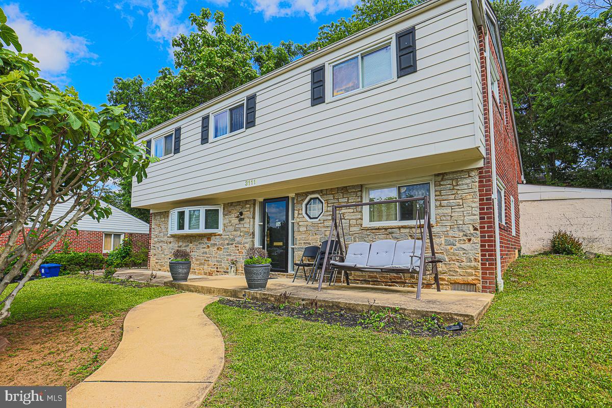 3111 Parkington Avenue Baltimore, MD 21215 - Photo 2 of 47 front view of a house with a yard