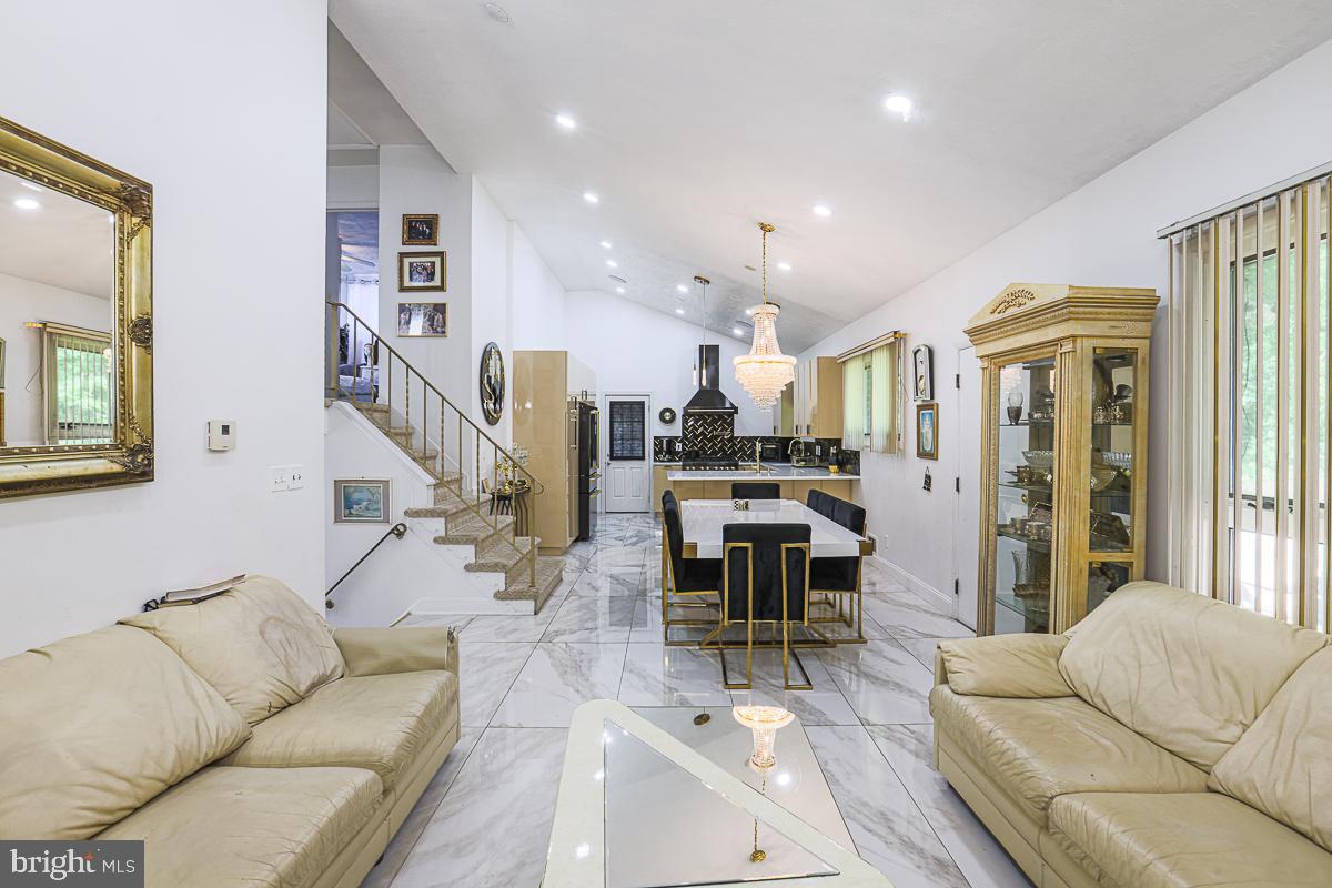 3111 Parkington Avenue Baltimore, MD 21215 - Photo 22 of 47 a living room with furniture kitchen view and a wooden floor