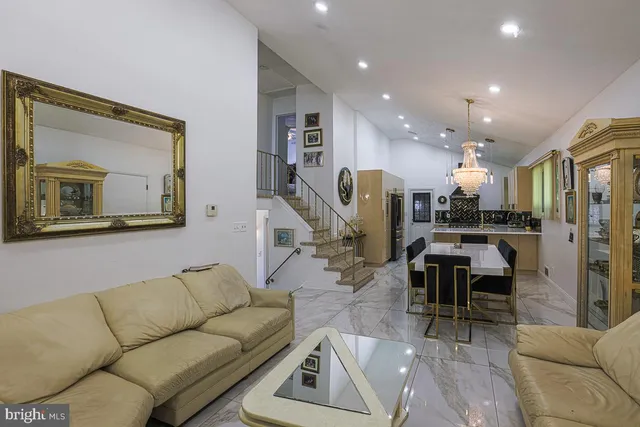 a living room with furniture and a view of kitchen