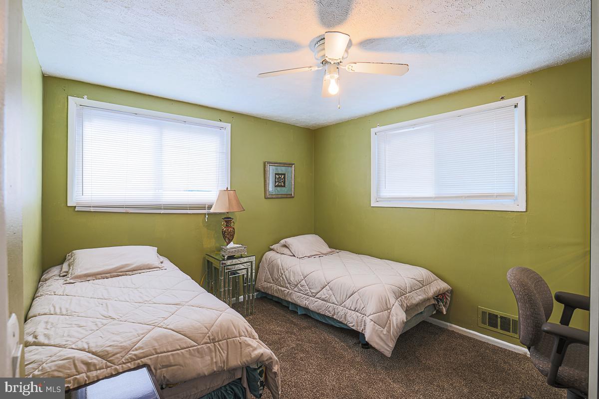 3111 Parkington Avenue Baltimore, MD 21215 - Photo 24 of 47 a bedroom with 2 bed and a chair