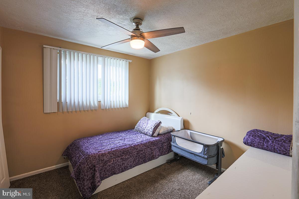 3111 Parkington Avenue Baltimore, MD 21215 - Photo 26 of 47 a bedroom with a bed and a chandelier