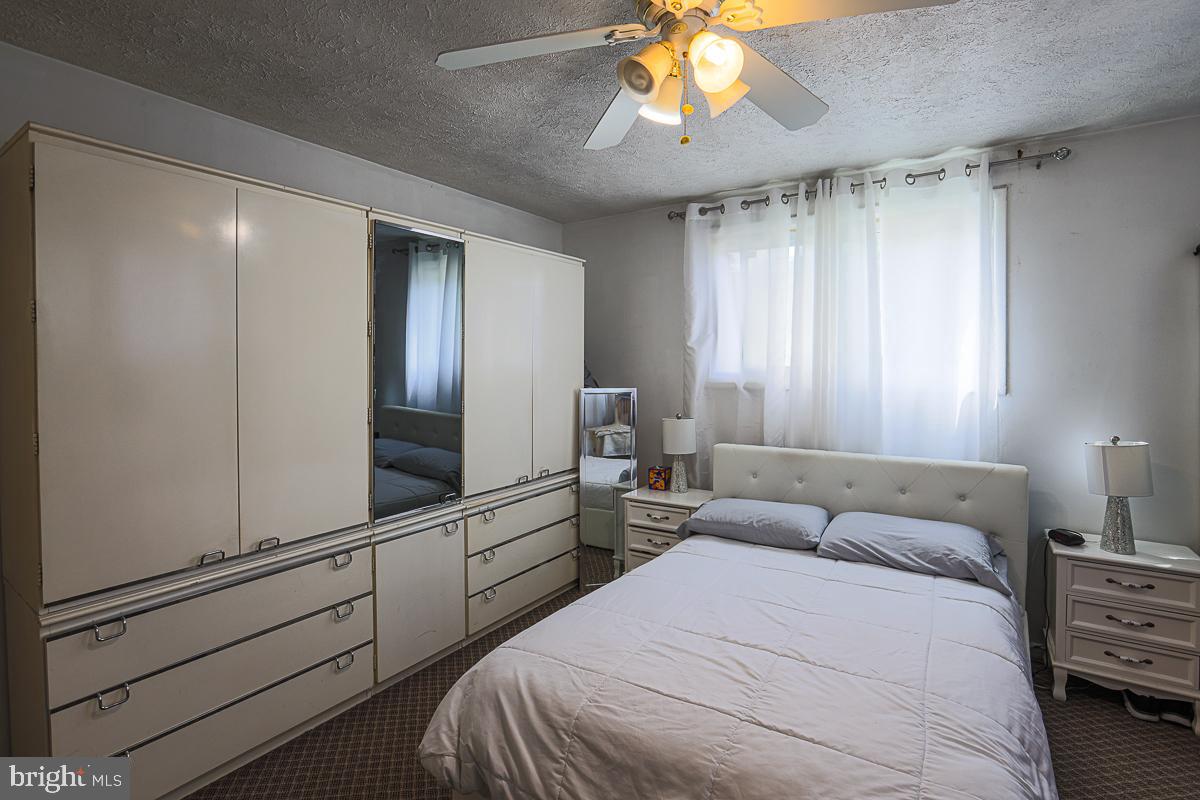 3111 Parkington Avenue Baltimore, MD 21215 - Photo 27 of 47 a bedroom with a bed and a chandelier