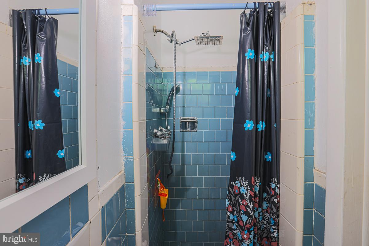 3111 Parkington Avenue Baltimore, MD 21215 - Photo 28 of 47 a bathroom with a shower and a sink