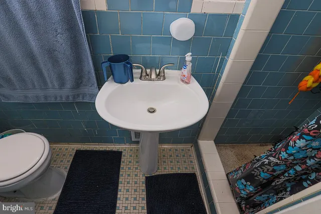 a bathroom with a sink mirror and toilet