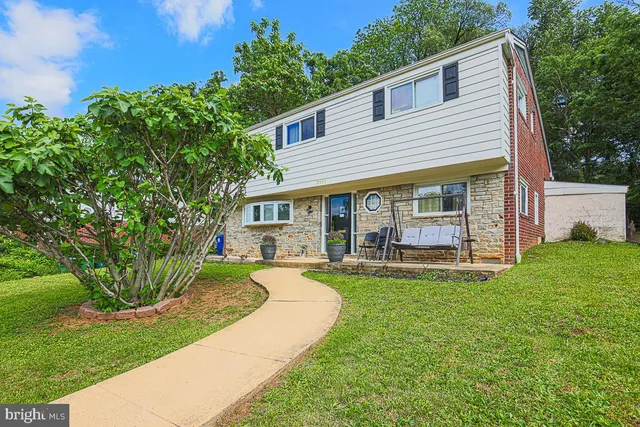 a view of a house with a yard and porch