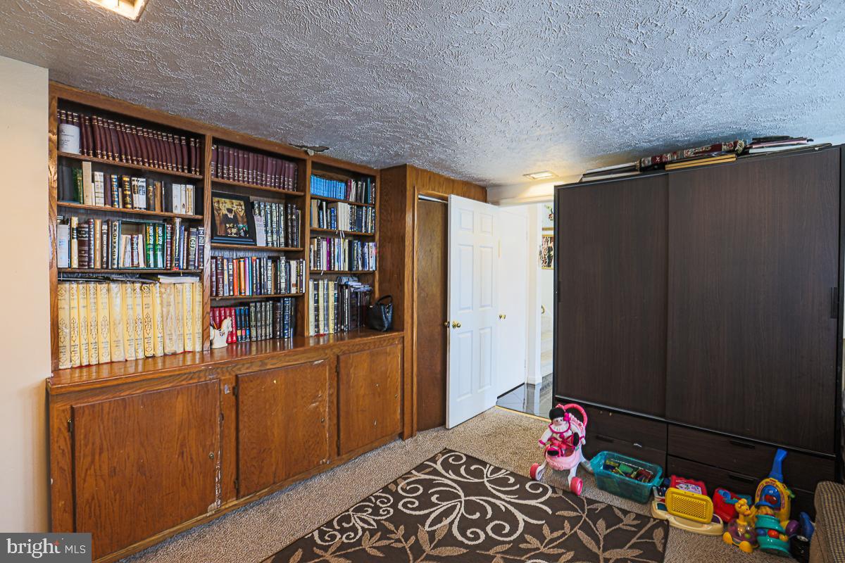 3111 Parkington Avenue Baltimore, MD 21215 - Photo 33 of 47 a bedroom with a bed and a book shelf
