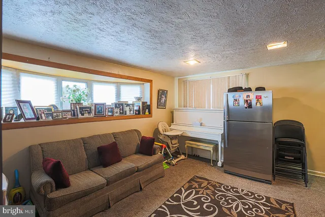 a view of a backyard with table and chairs a barbeque and fence