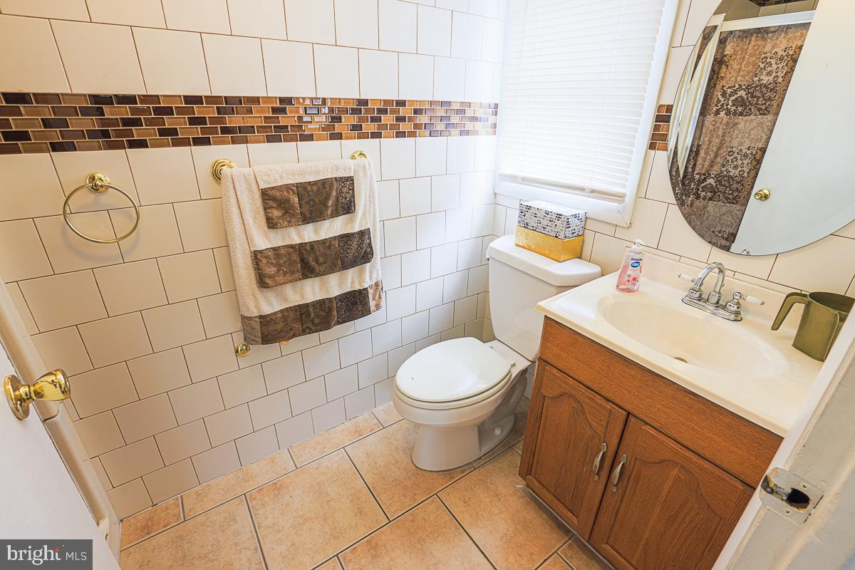 3111 Parkington Avenue Baltimore, MD 21215 - Photo 36 of 47 a white toilet sitting next to a bathroom sink