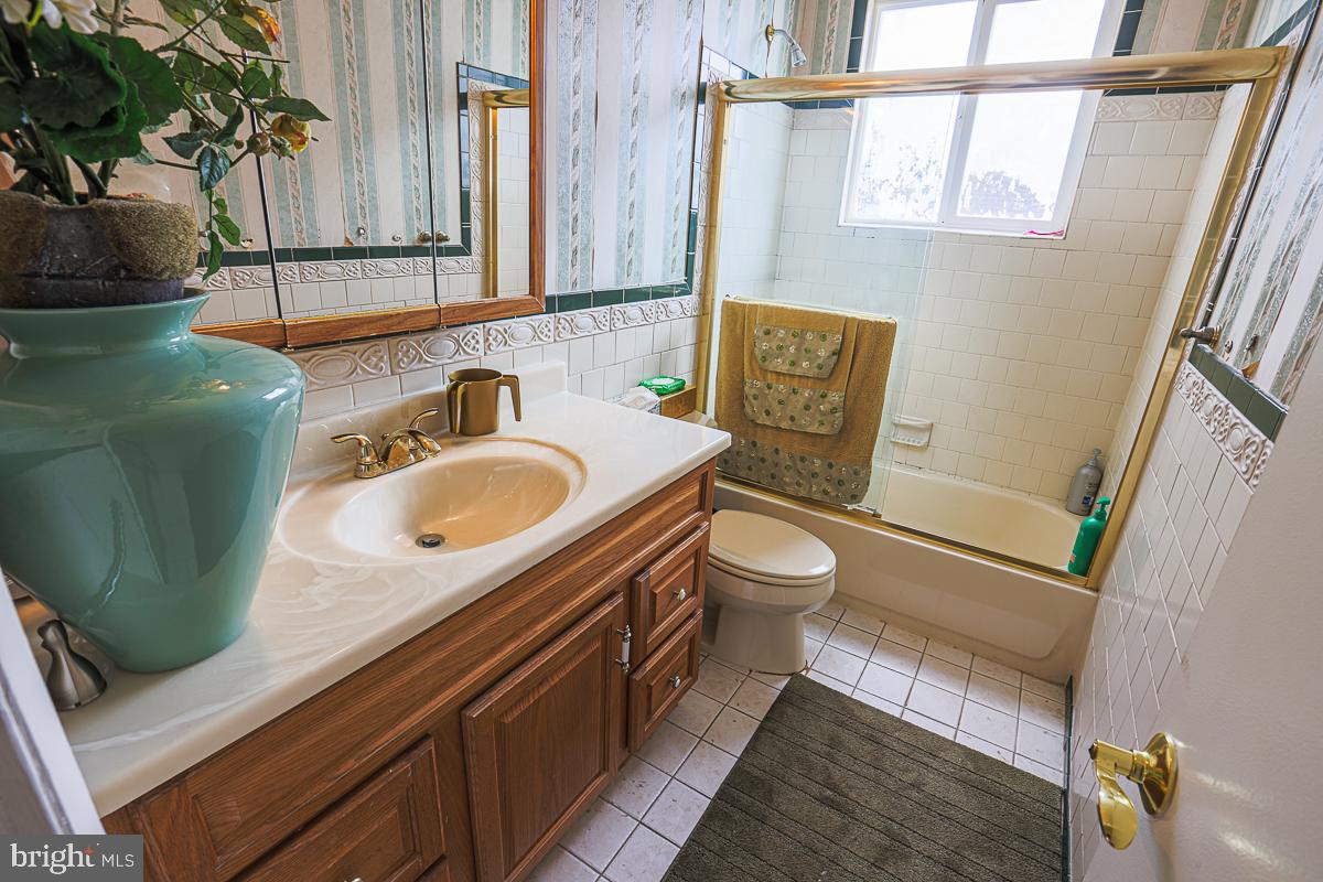3111 Parkington Avenue Baltimore, MD 21215 - Photo 37 of 47 a bathroom with a sink a toilet and mirror