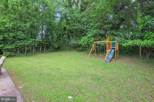 a front view of house with yard patio and fire pit