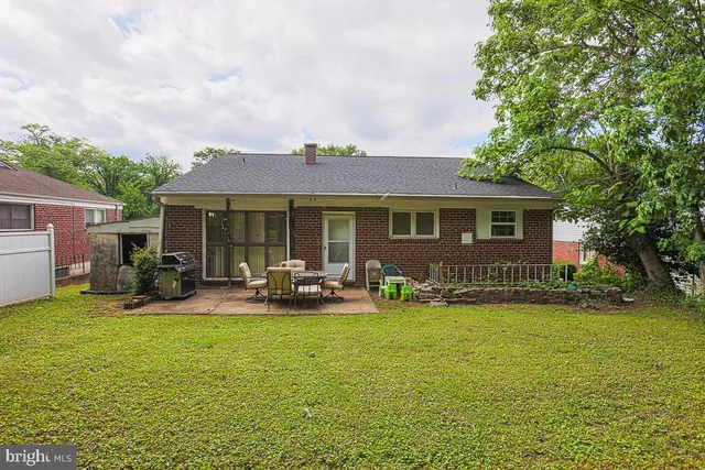 a view of a house with backyard porch and sitting area