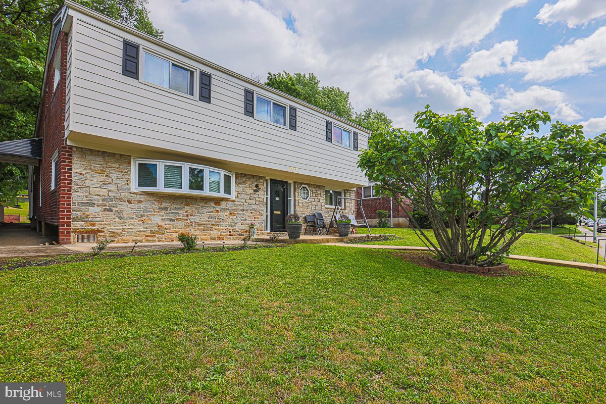 3111 Parkington Avenue Baltimore, MD 21215 - Photo 45 of 47 front view of a house with a yard