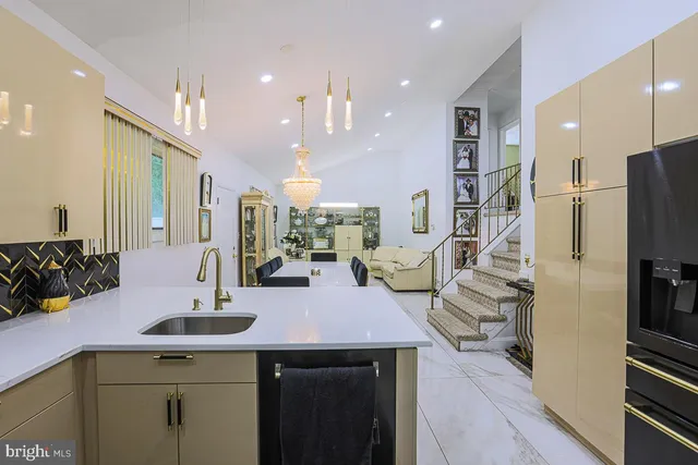 a kitchen with stainless steel appliances kitchen island granite countertop a sink and cabinets