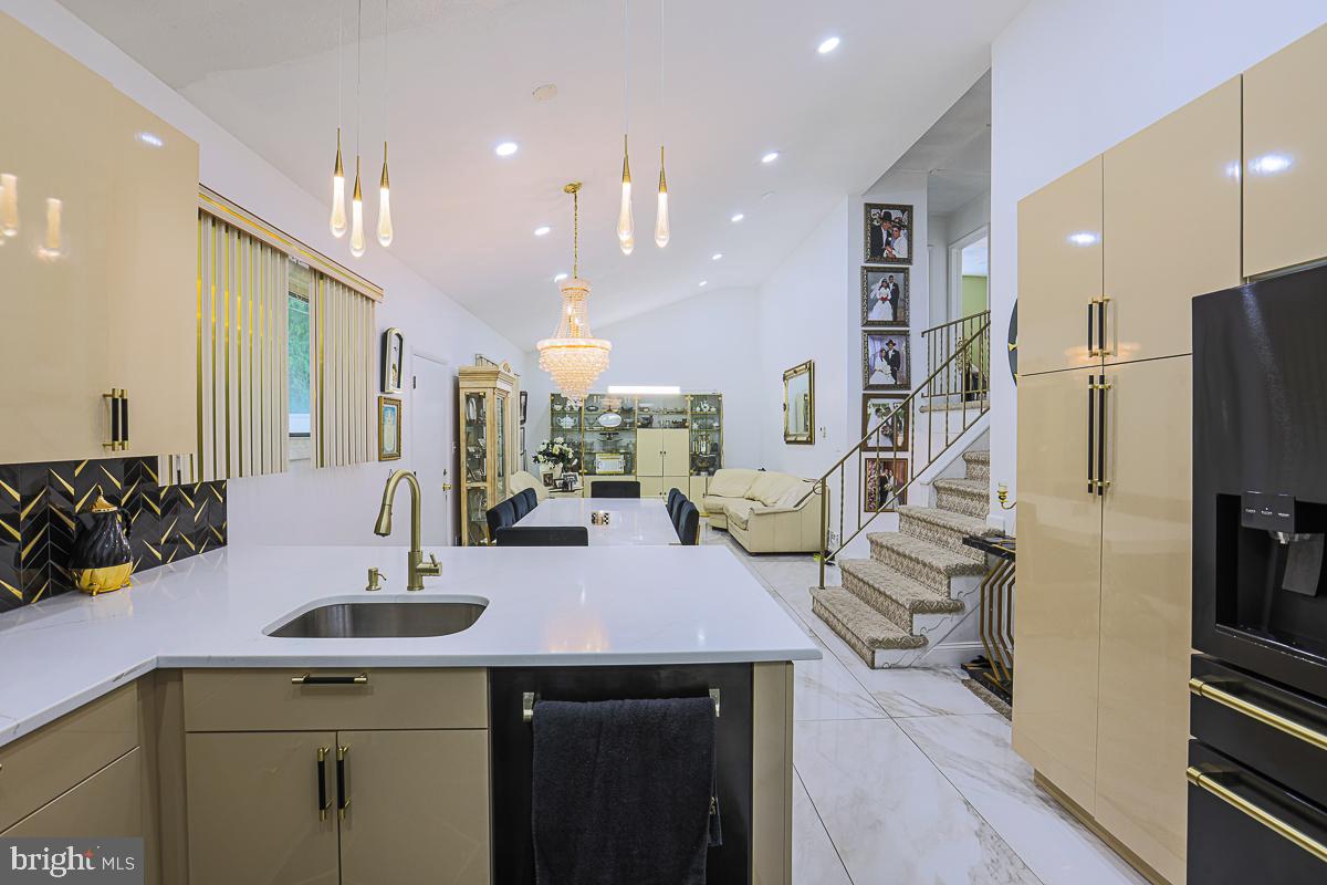 3111 Parkington Avenue Baltimore, MD 21215 - Photo 6 of 47 a kitchen with stainless steel appliances kitchen island granite countertop a sink and cabinets