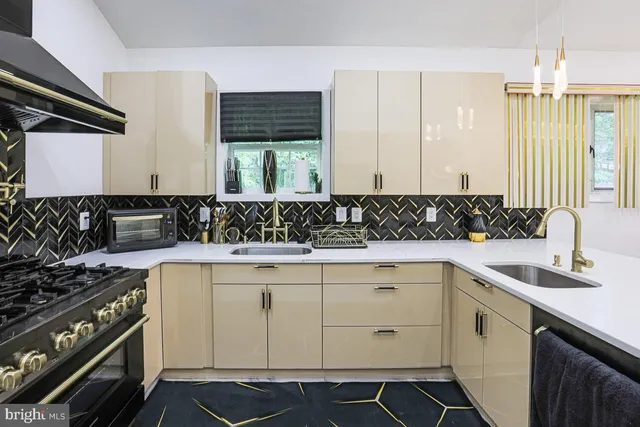 a view of a kitchen sink dishwasher stove and cabinets