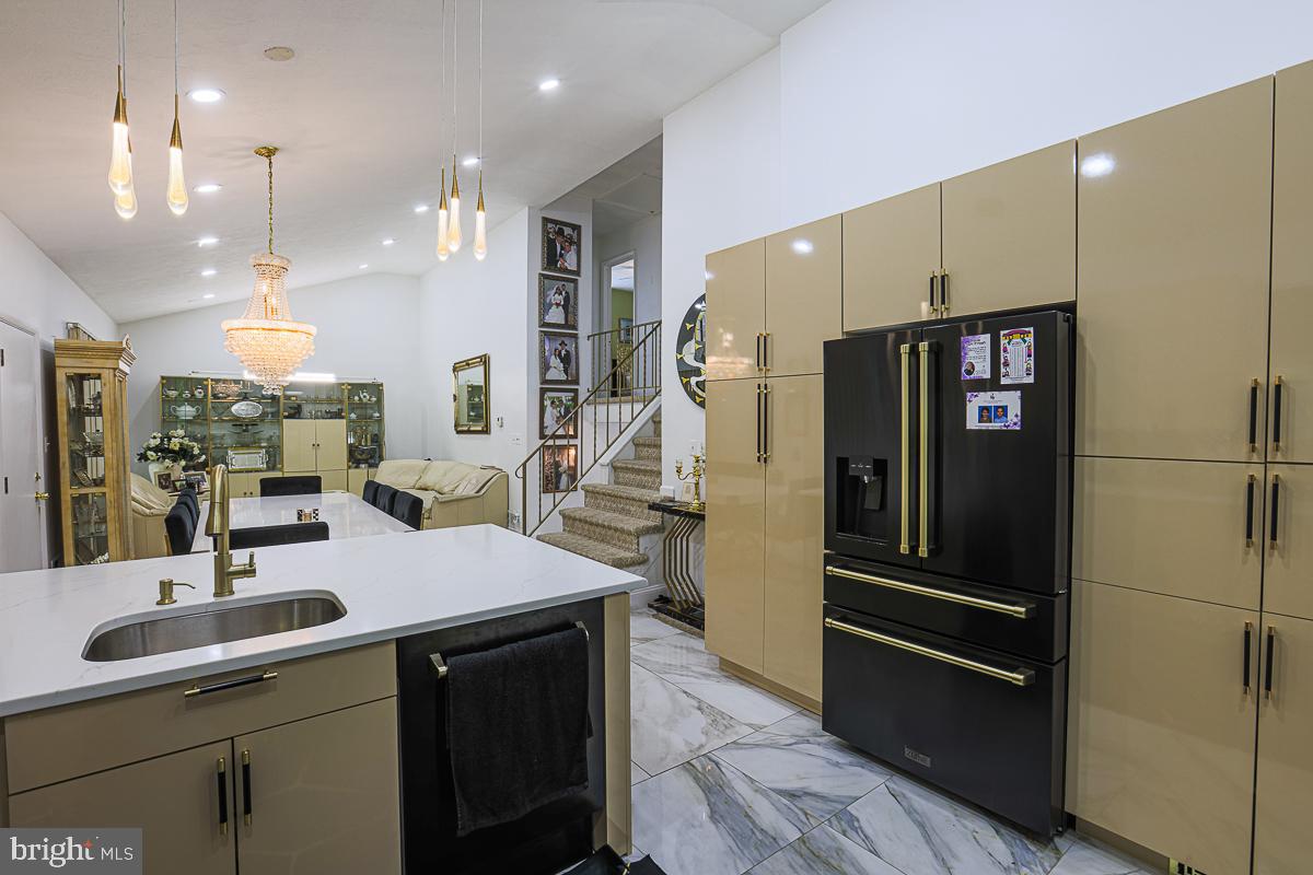 3111 Parkington Avenue Baltimore, MD 21215 - Photo 8 of 47 a kitchen with stainless steel appliances kitchen island granite countertop a refrigerator and a sink